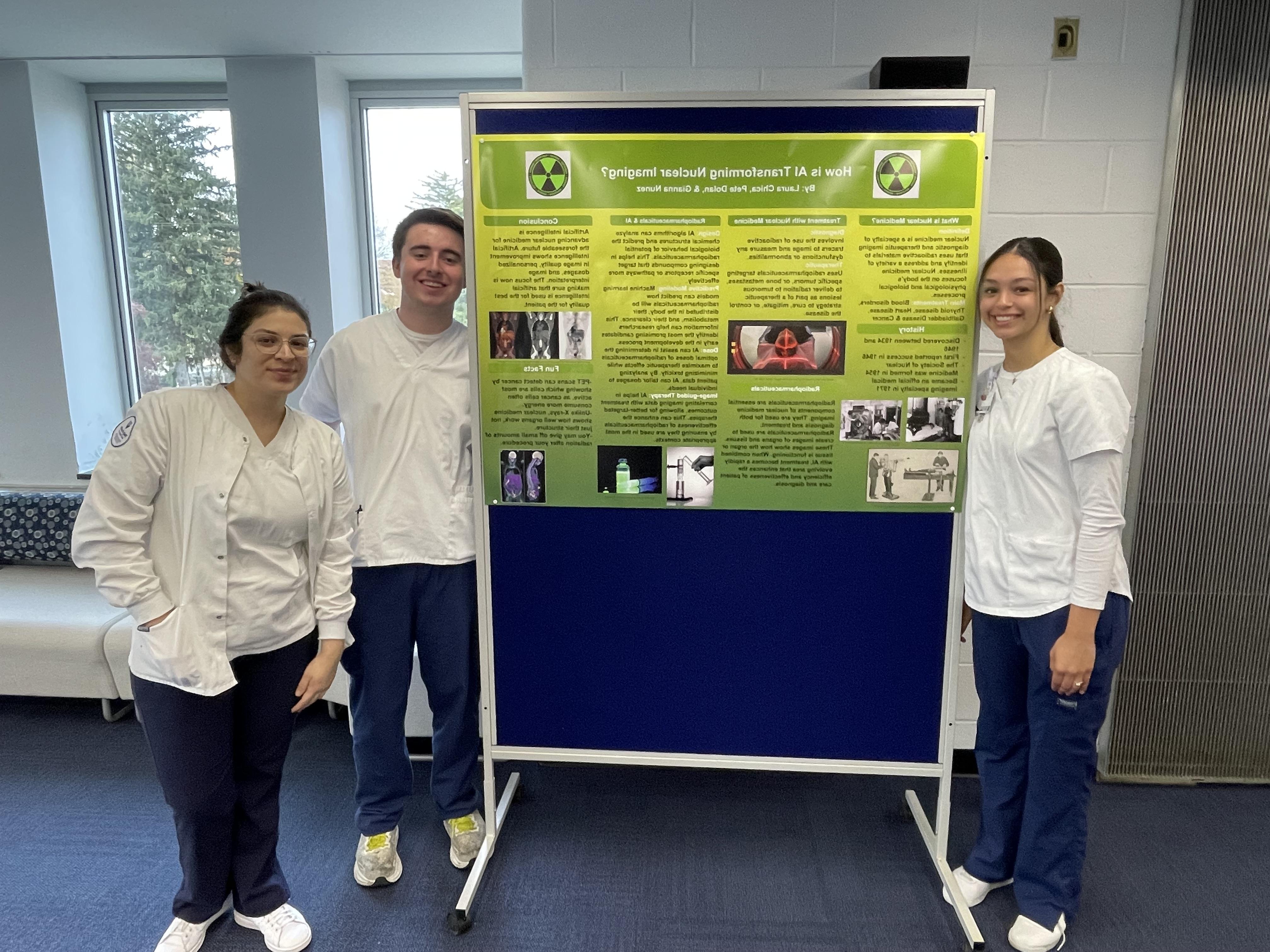 Students present poster on nuclear imaging.